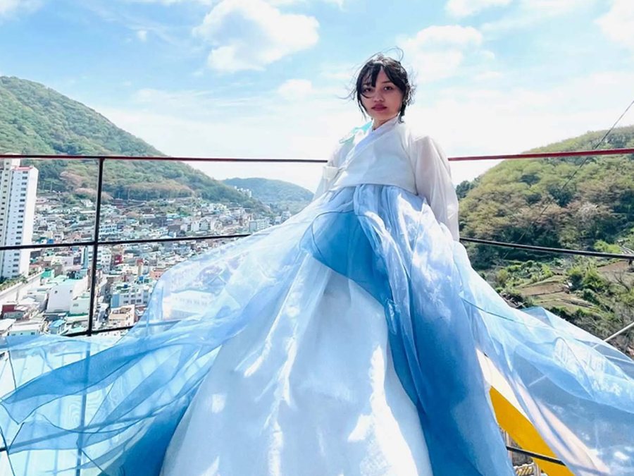 Wearing hanbok on a rooftop overlooking Gamcheon Culture Village, photo courtesy of Cheolsu & Younghee